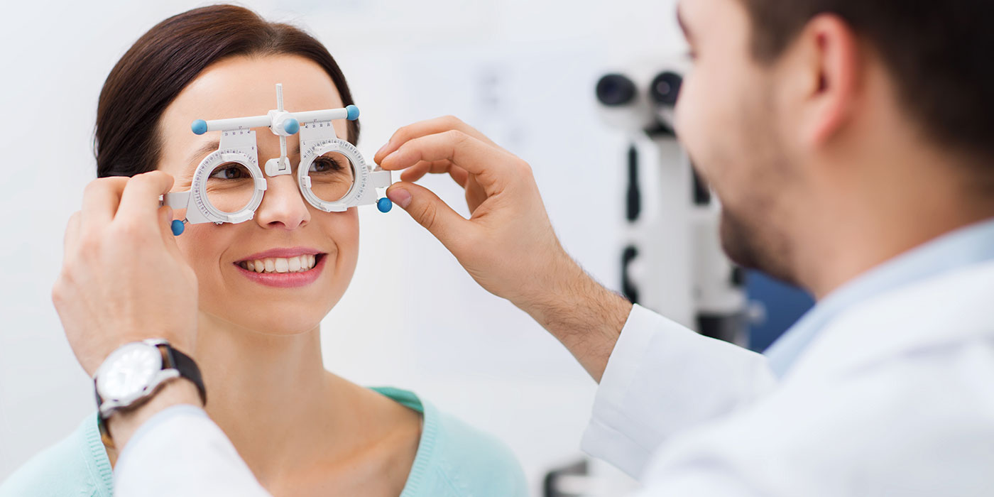 Optician working with happy patient