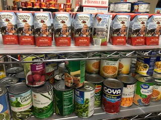 Food Pantry shevling stocked with various canned goods