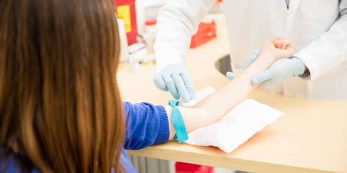 Doctor placing an apple into the hand of a patient