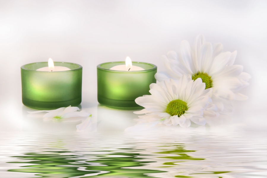 lit candles accentuating aroma in massage therapy