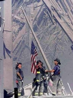 firefighters raising flag at WTC site