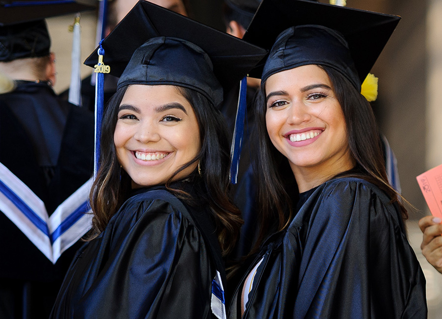 two female students at graduation