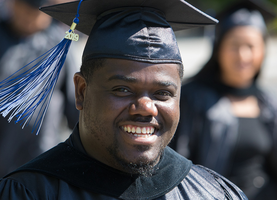 male student smiling at graduation