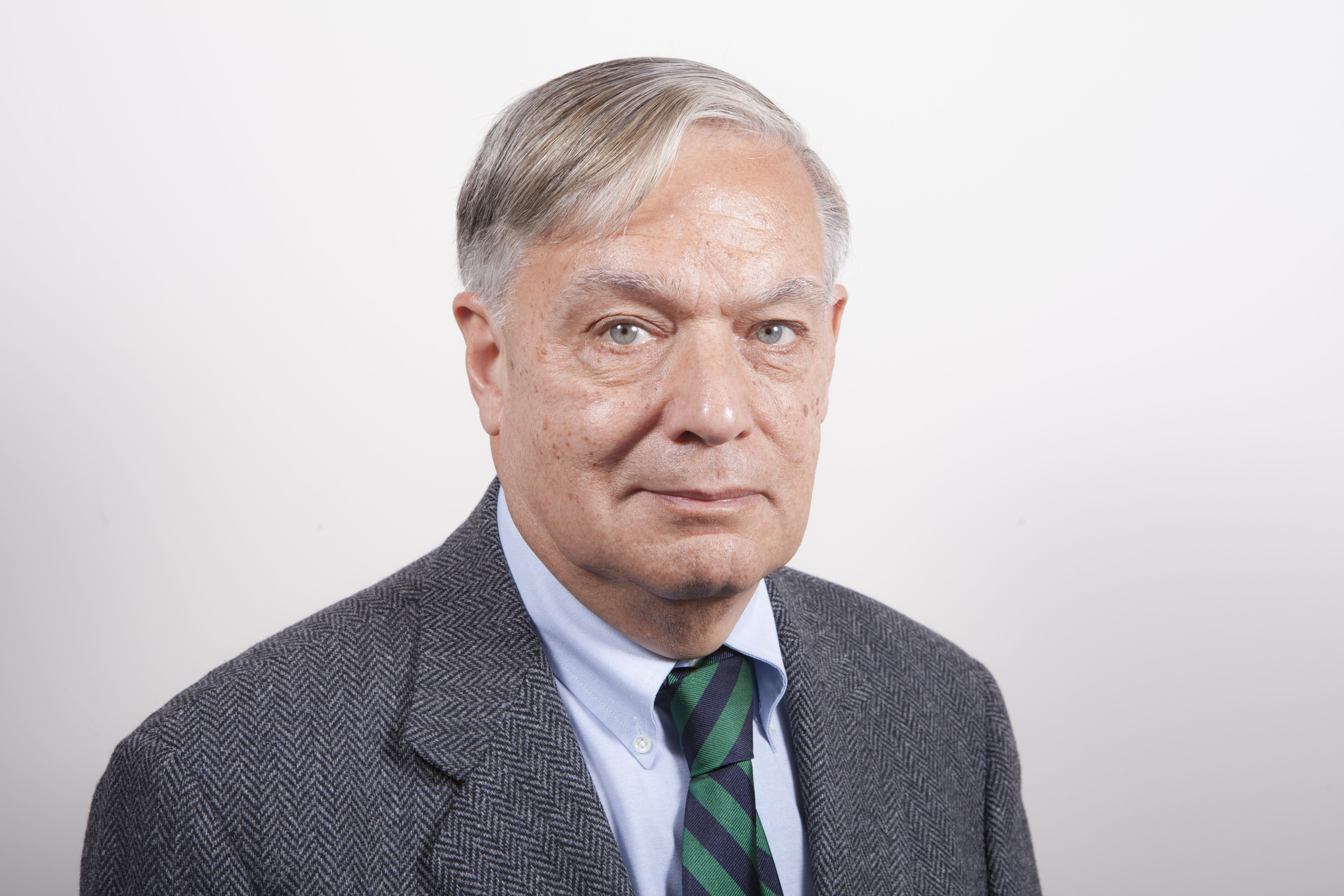 Archie Calise wearing a green striped tie and dark blue suit