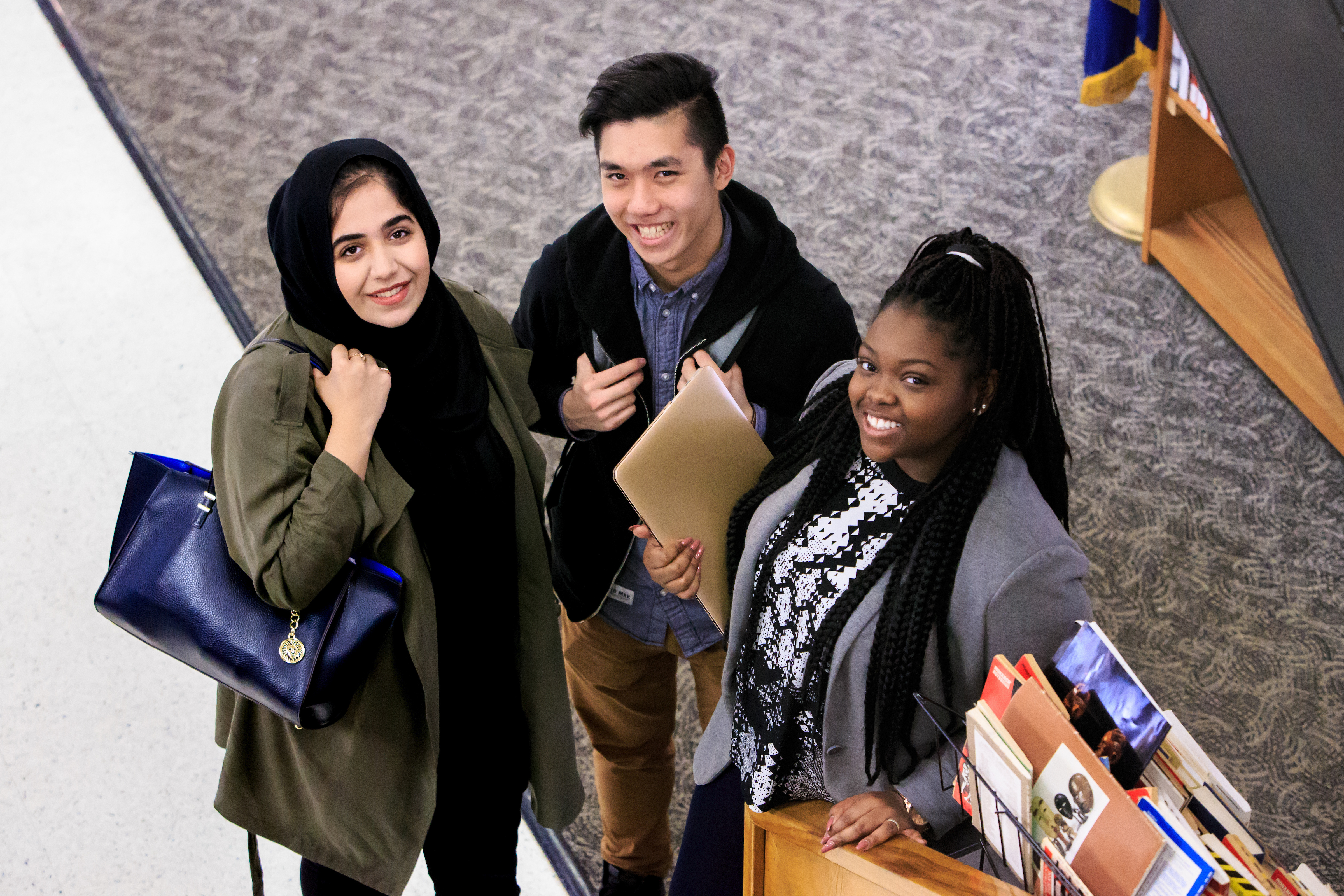 3 students in a library