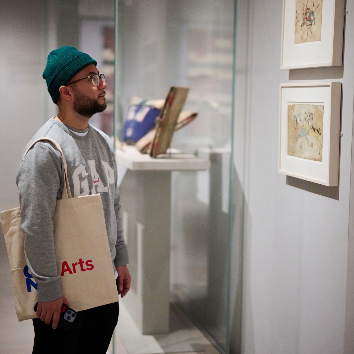 Man Standing Admiring Art On Wall