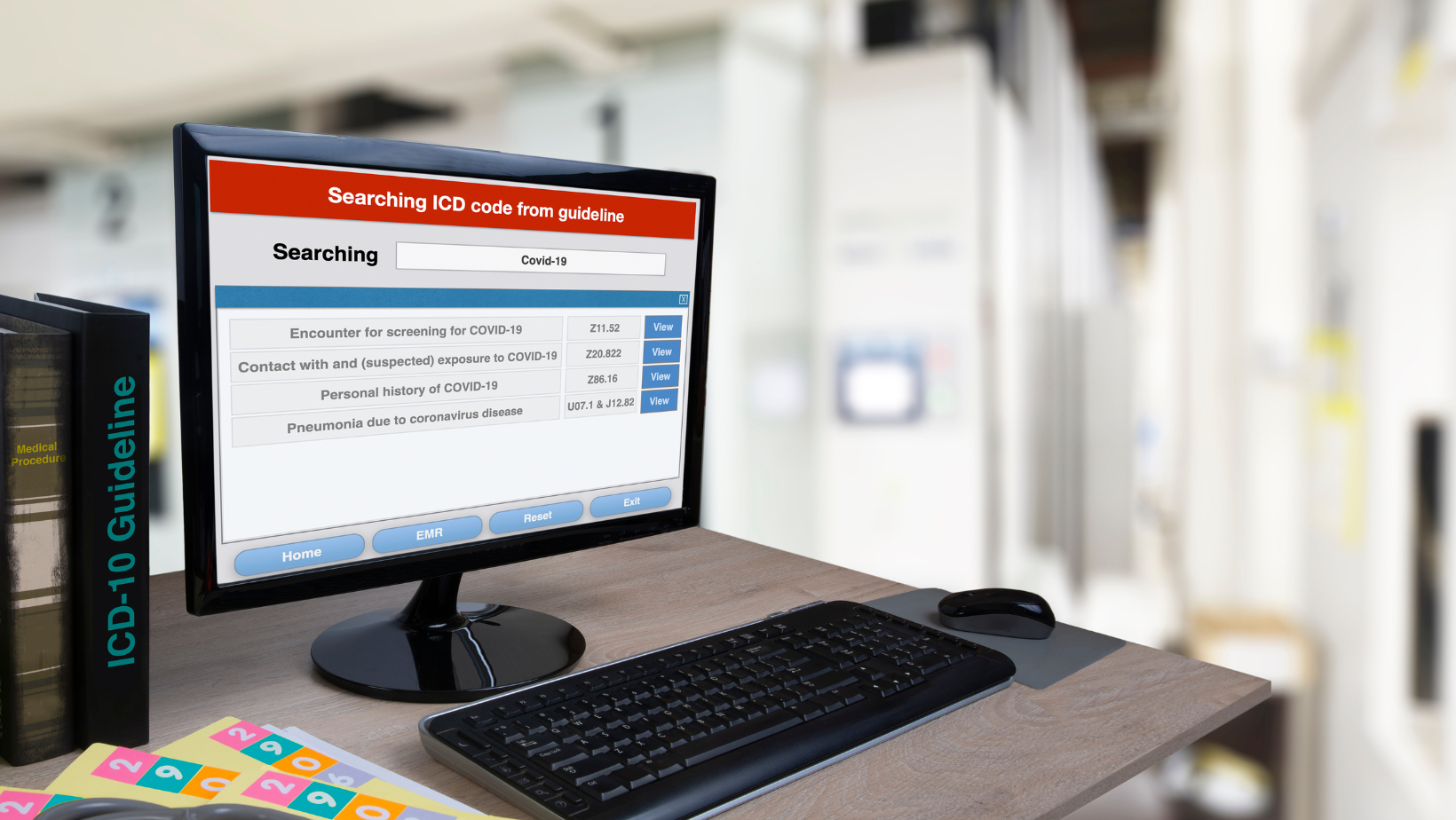 Person sitting at a desk entering in CPT coding records onto the screen