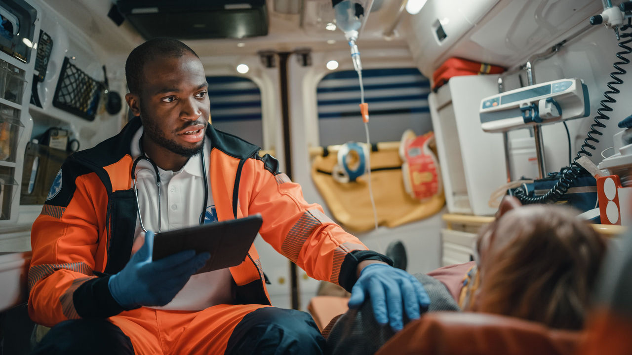 Photo of an EMT treating a patient in an ambulance