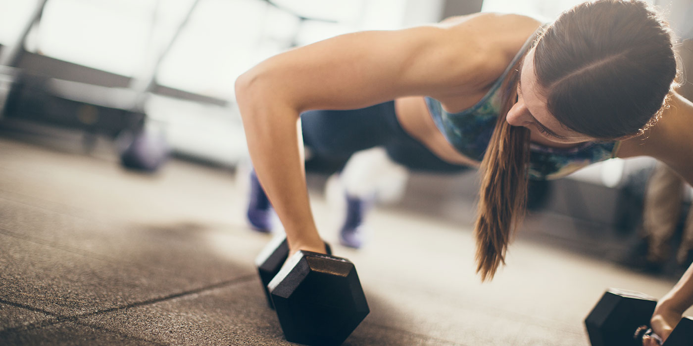 personal trainer exercising with weights