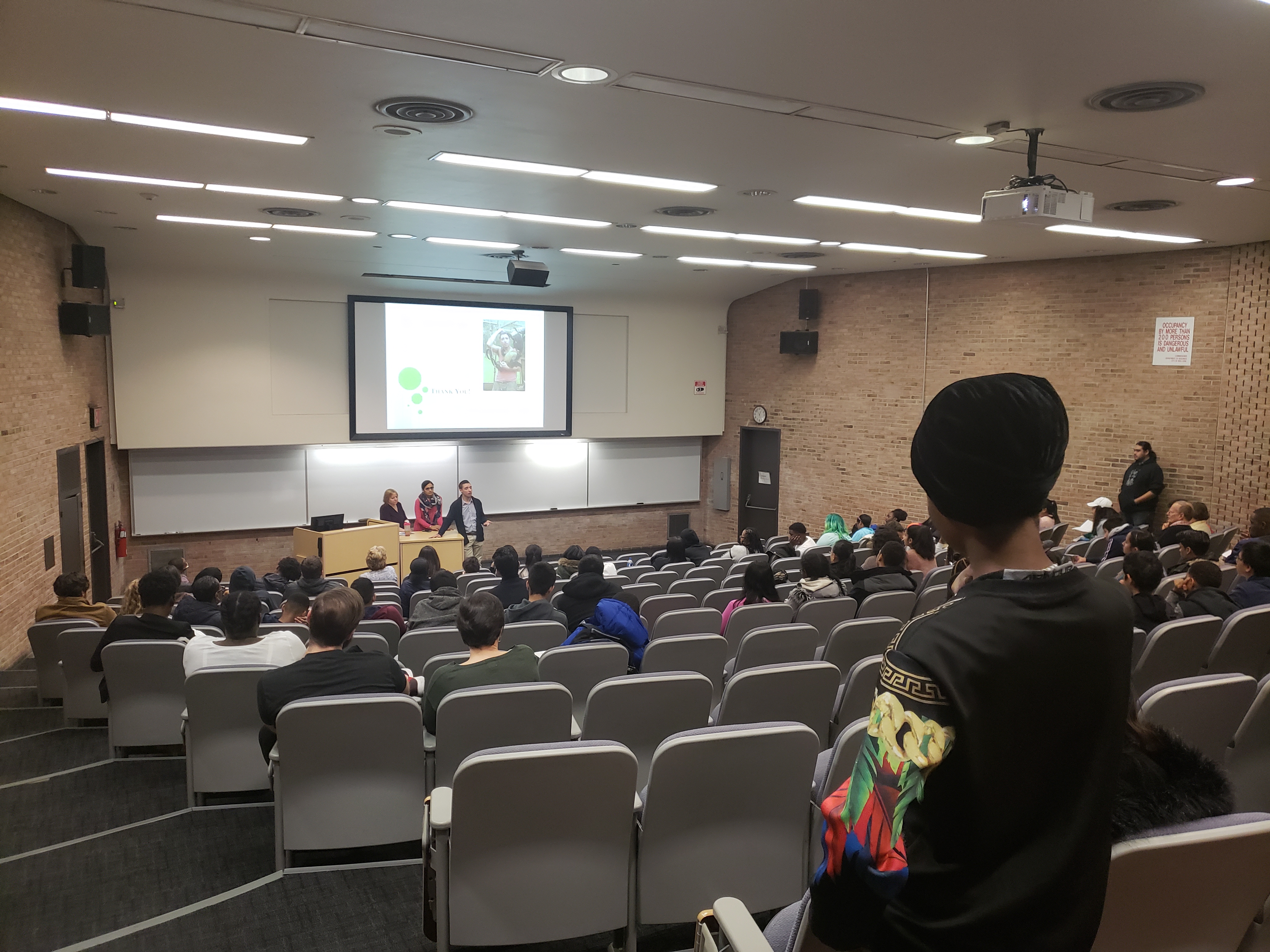 auditorium of students listening to presenters