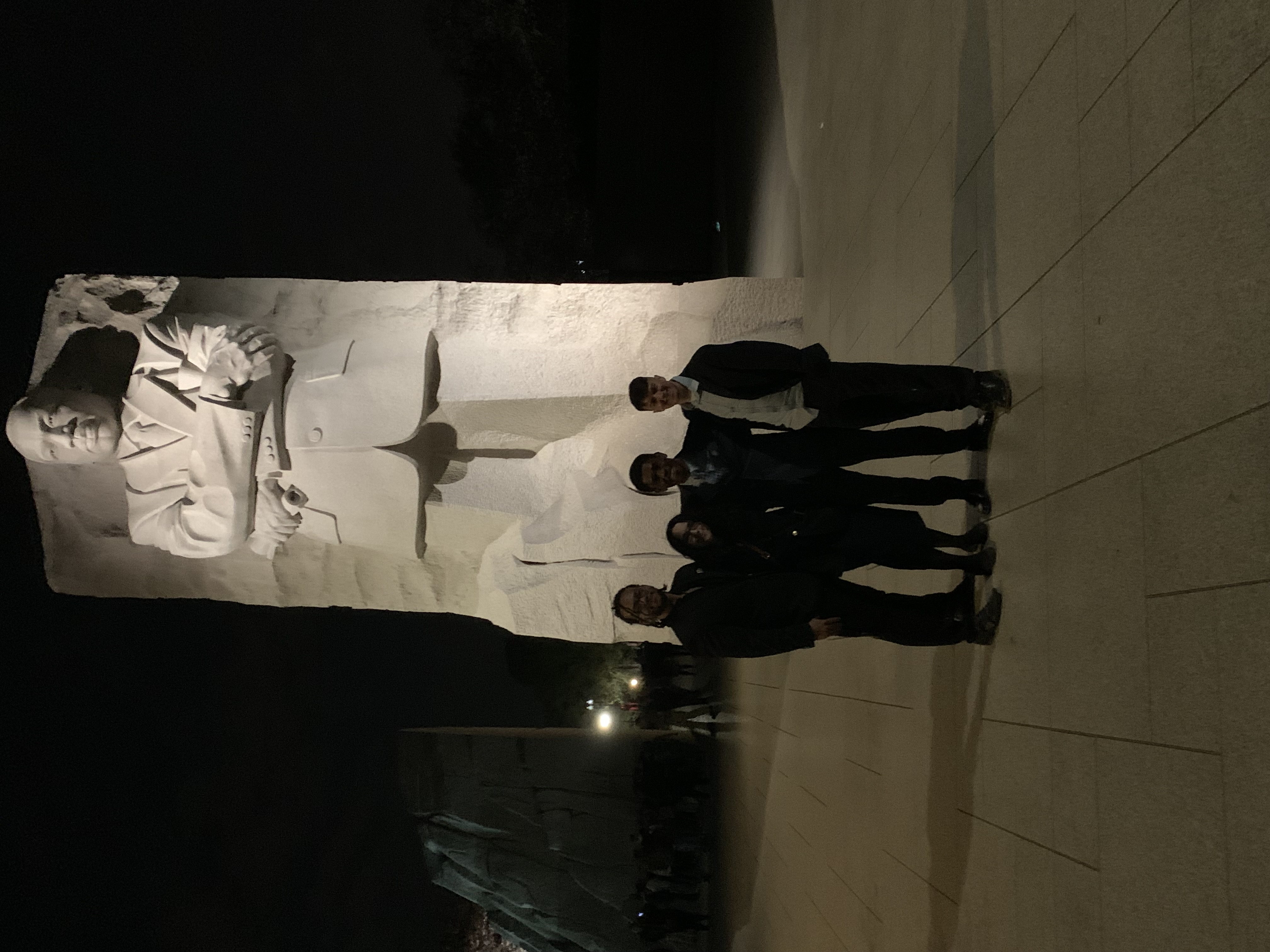 Blackstone Launchpad students standing in front of statue