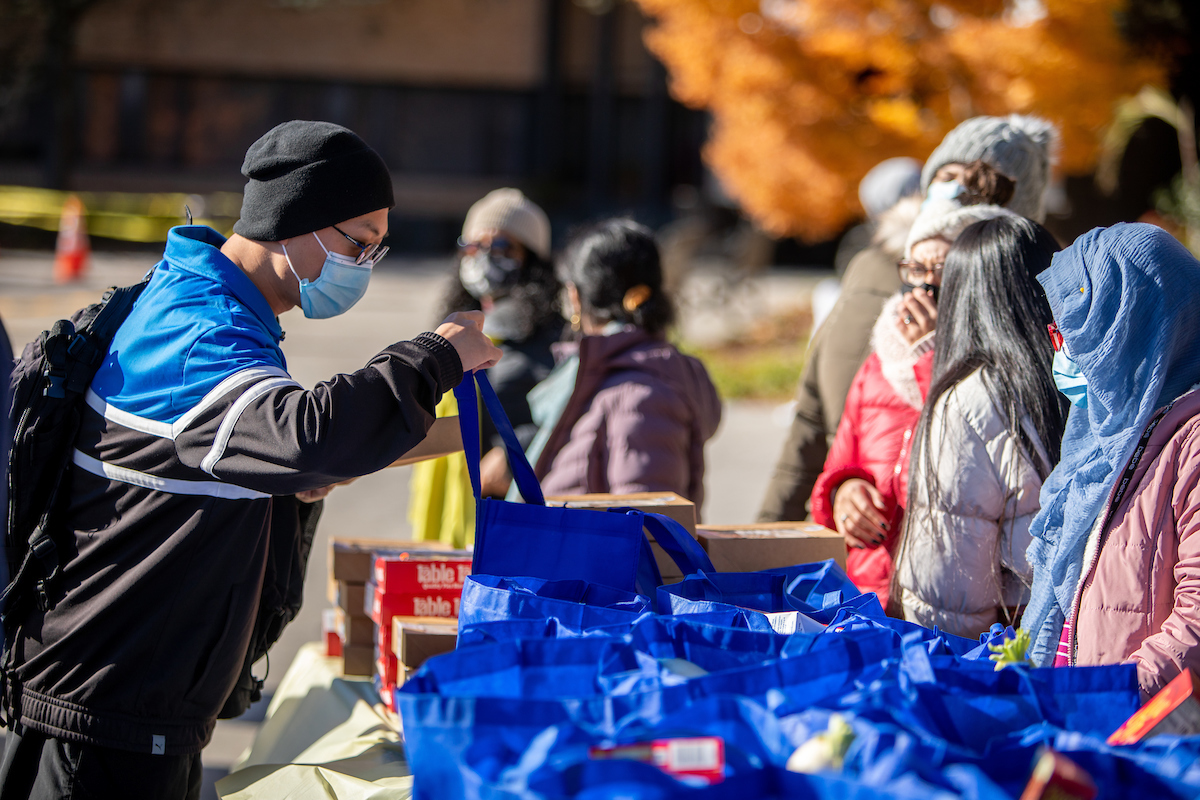 student receiving food pantry items