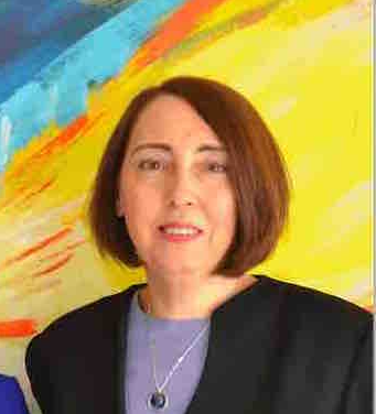 Headshot of Dona Boccio smiling with colorful yellow background