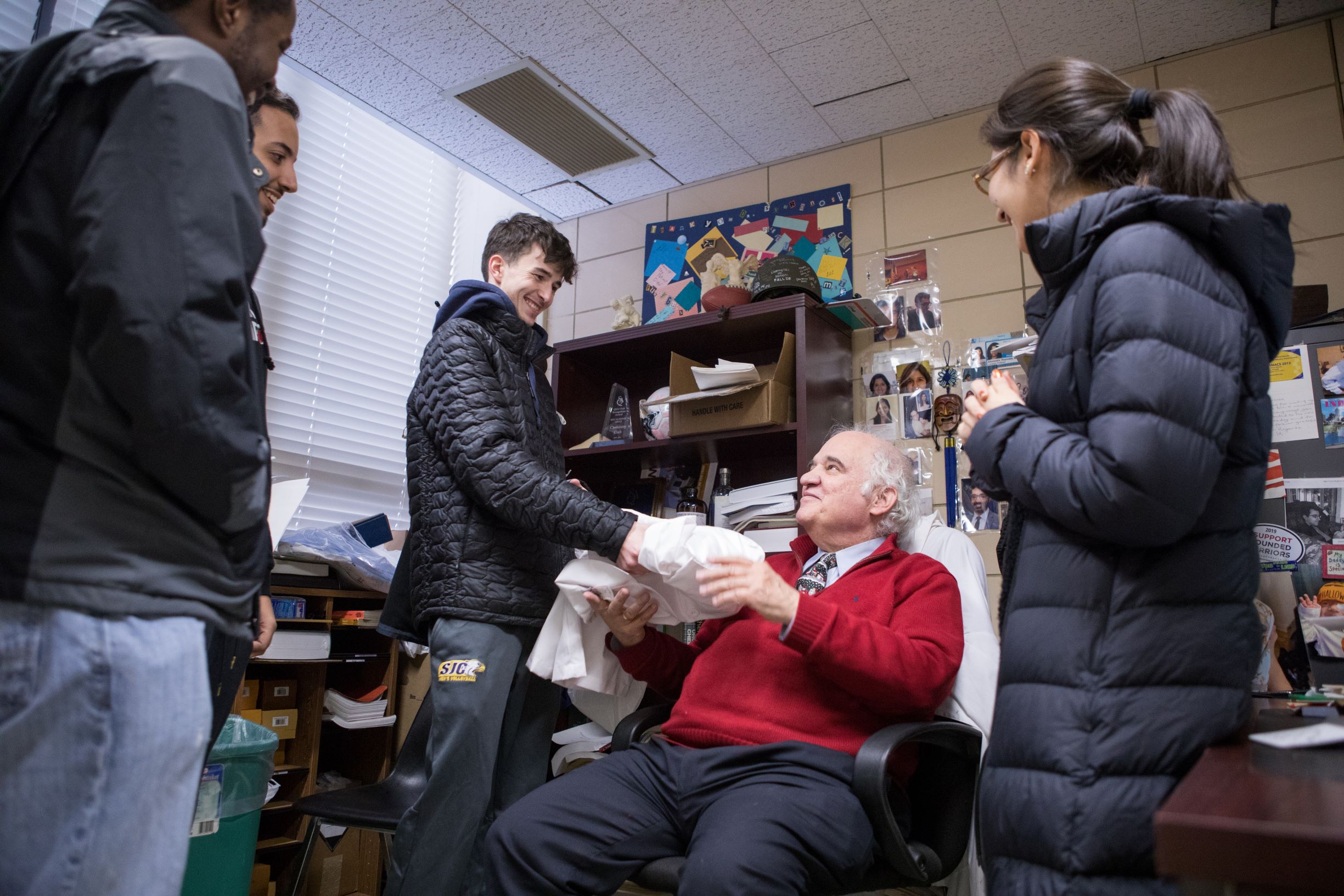 Students present Dr. Svoronos with a thank you card and a new lab coat at the end of the Fall 2019 semester