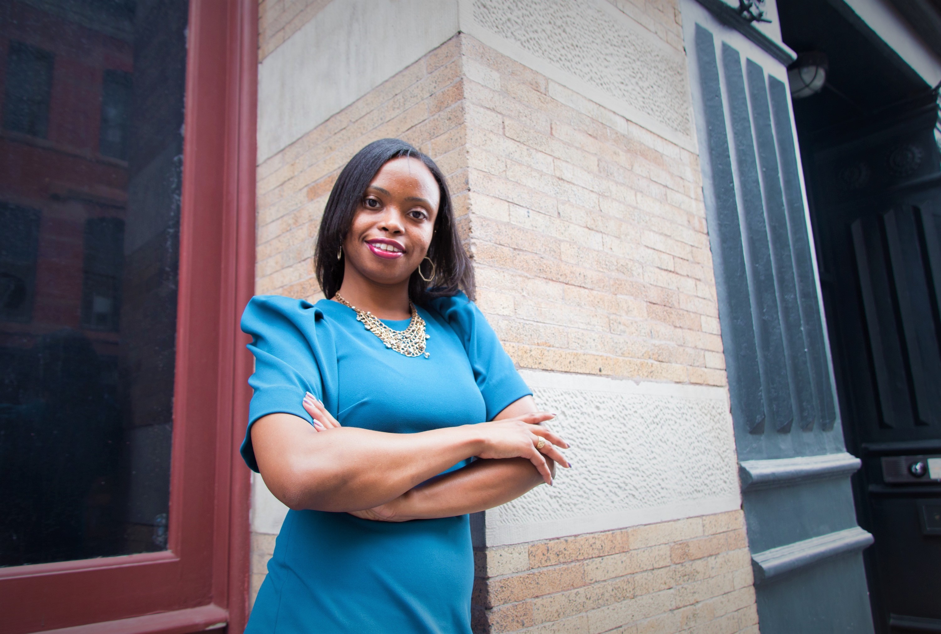 LaToya Benjamin arms crossed and wearing a teal dress