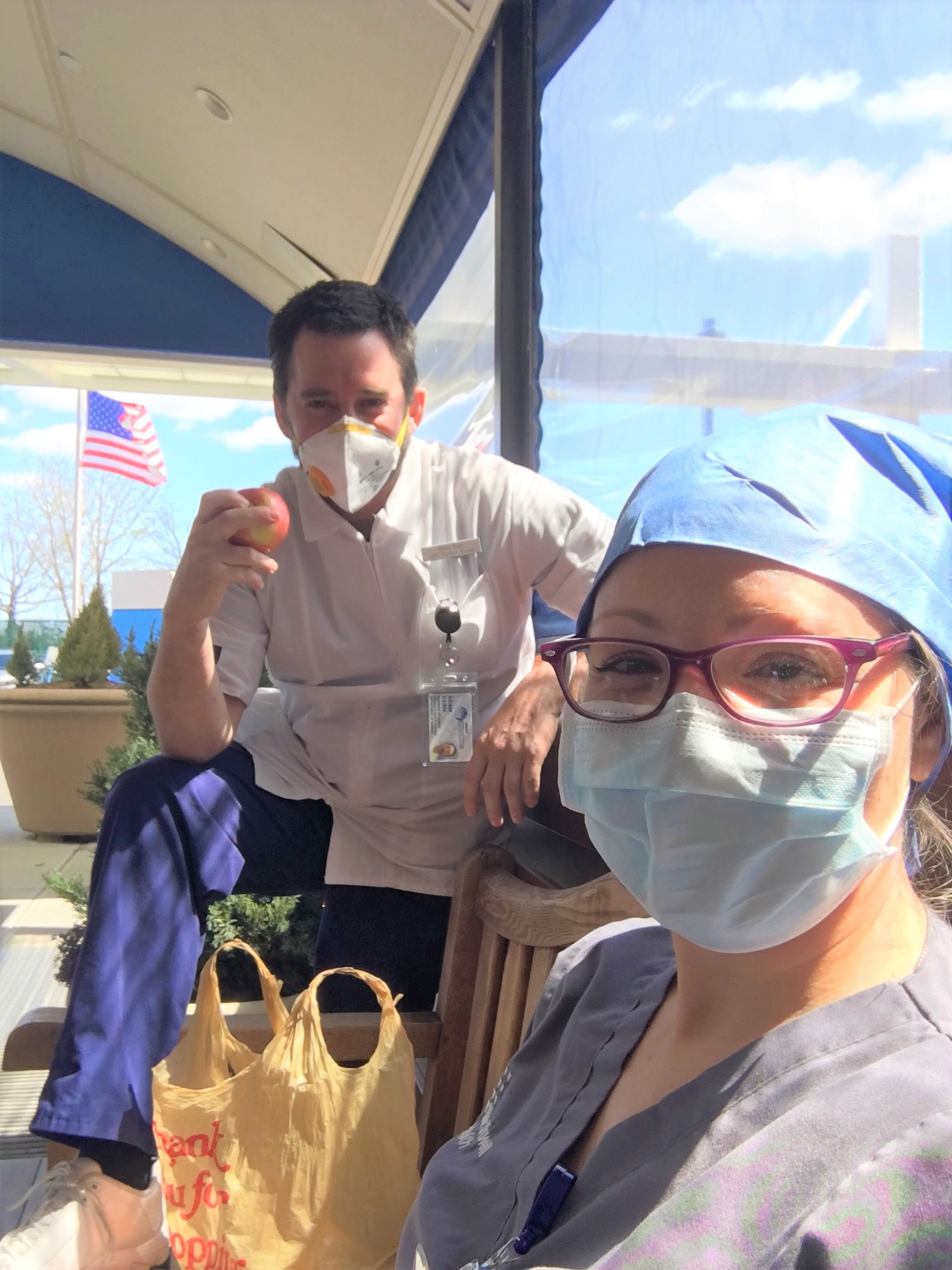 Nursing students Kristen Rodriguez and Adam Kern, wearing masks and on a work break.