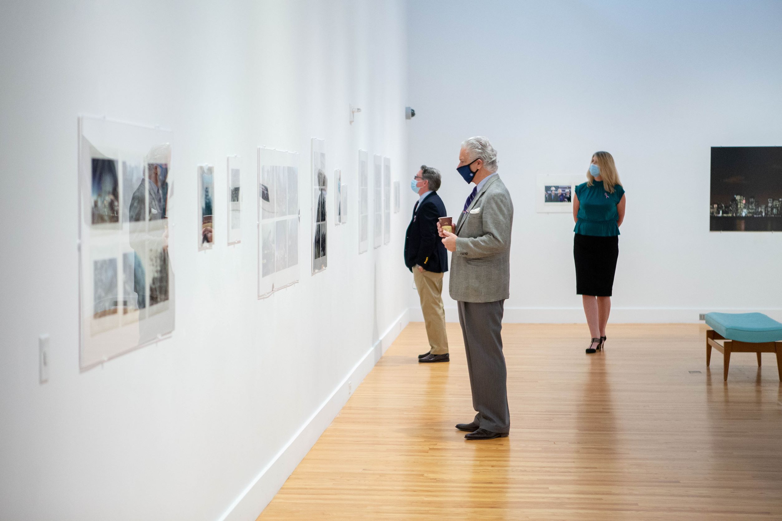 Queensborough’s Mike Donahue, Dr. Arthur Corradetti, and Dr. Christine Mangino view Chris Landano’s images.