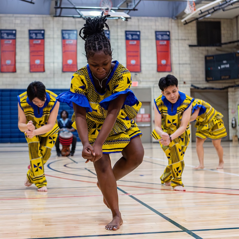 Kwanzaa celebration with students dancing