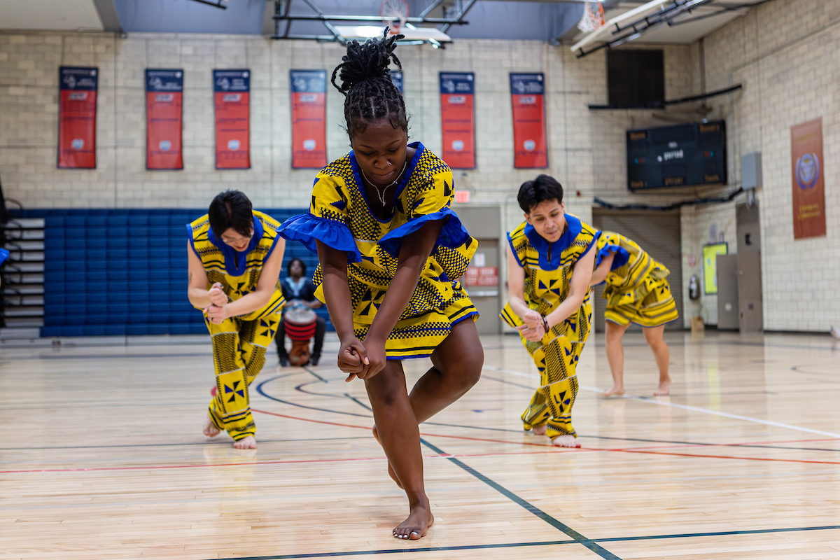 Kwanzaa celebration with students dancing
