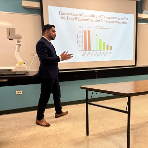student wearing black suit and presenting his research