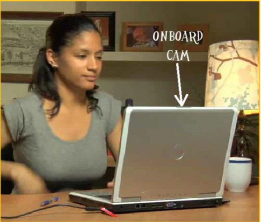 girl sitting at a desk looking into a laptop
