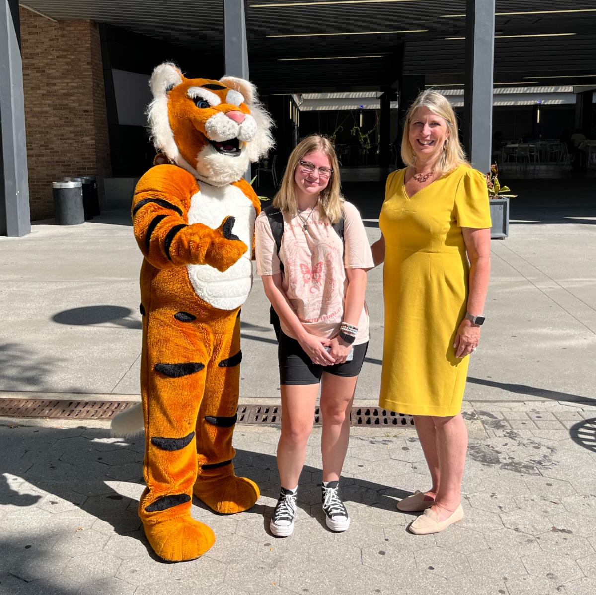 President Mangino with student and mascot