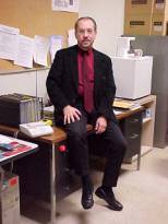 photo of instructor sitting on a desk