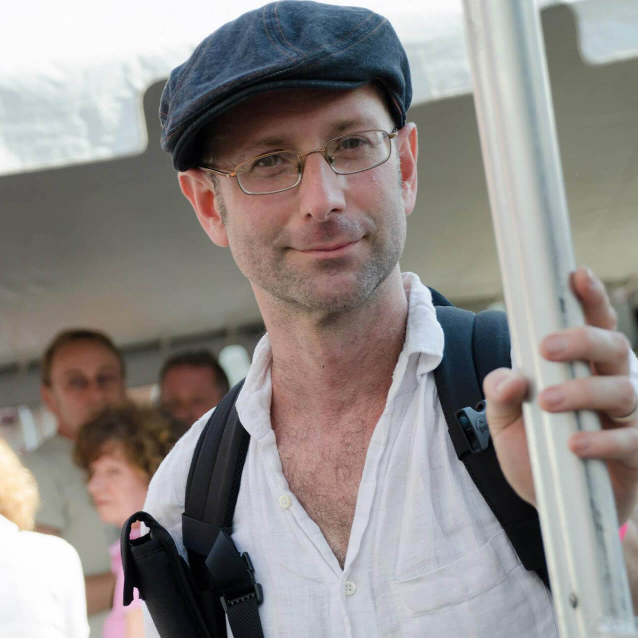 headshot of Documentarian Richard Shpuntoff wearing cap and glasses