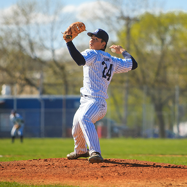 male student playing baseball on the field