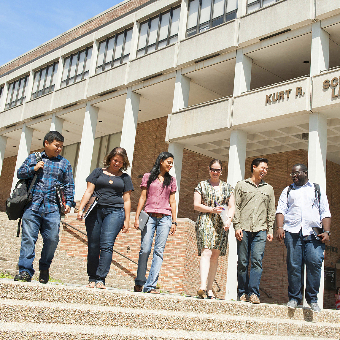 group of students walking together on campus and smiling